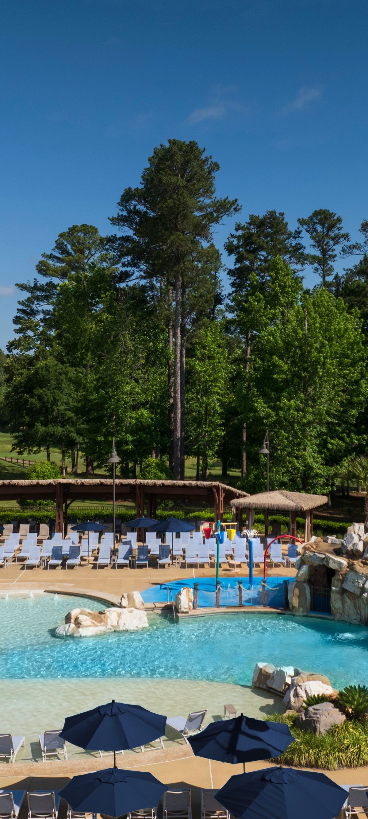 Outdoor pool with rock waterfall and deck