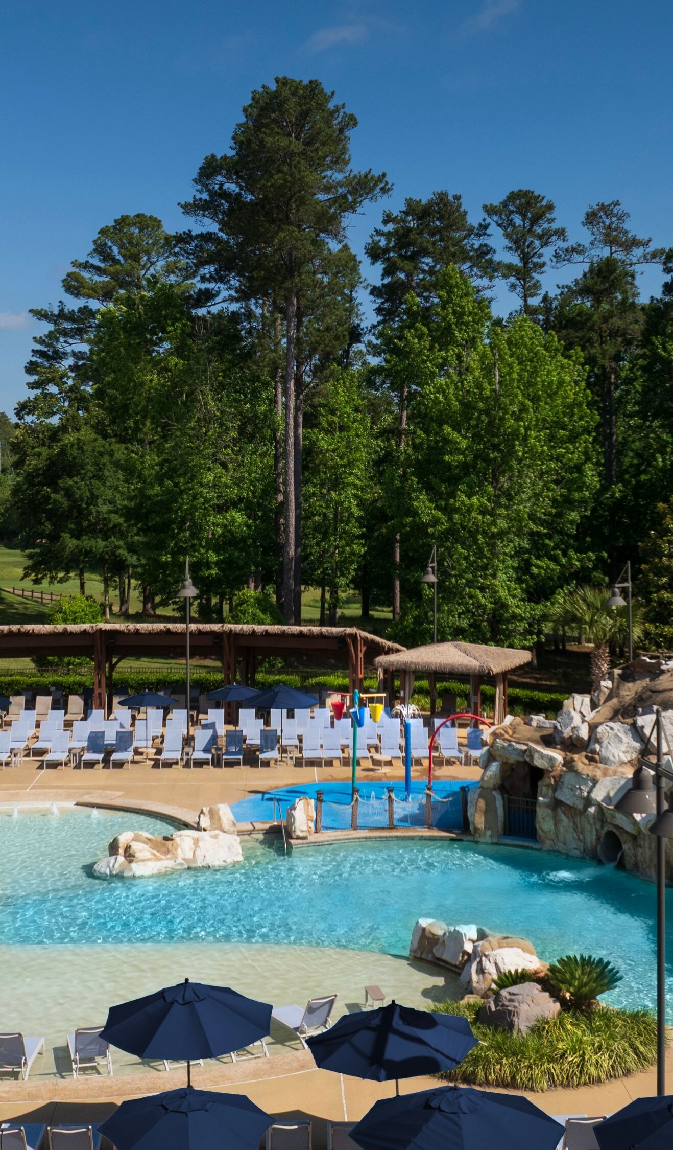 Outdoor pool with rock waterfall and deck