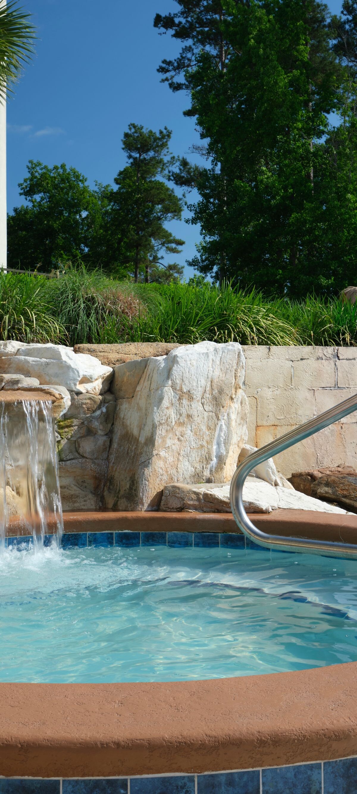Outdoor whirlpool with rock waterfall