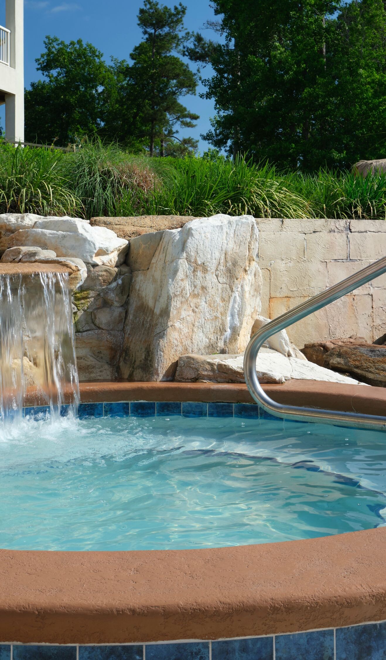 Outdoor whirlpool with rock waterfall