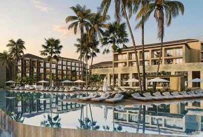 Resort pool with loungers and palm trees