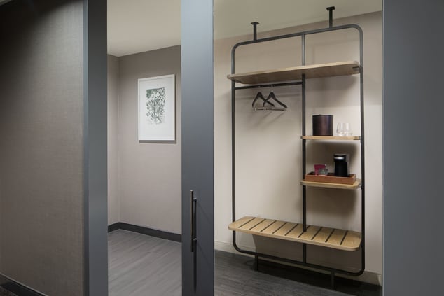Open closet with rack to hang clothes, shelves 
