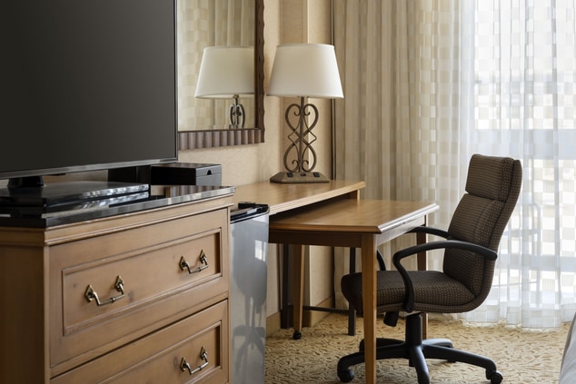 Work desk in guest room with chair and lamp