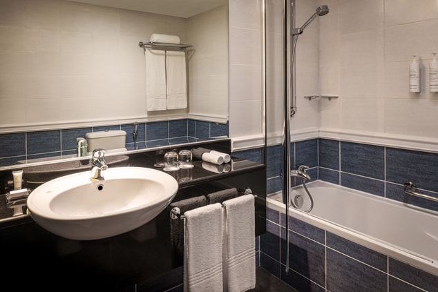 Bathroom area with amenities and large mirror