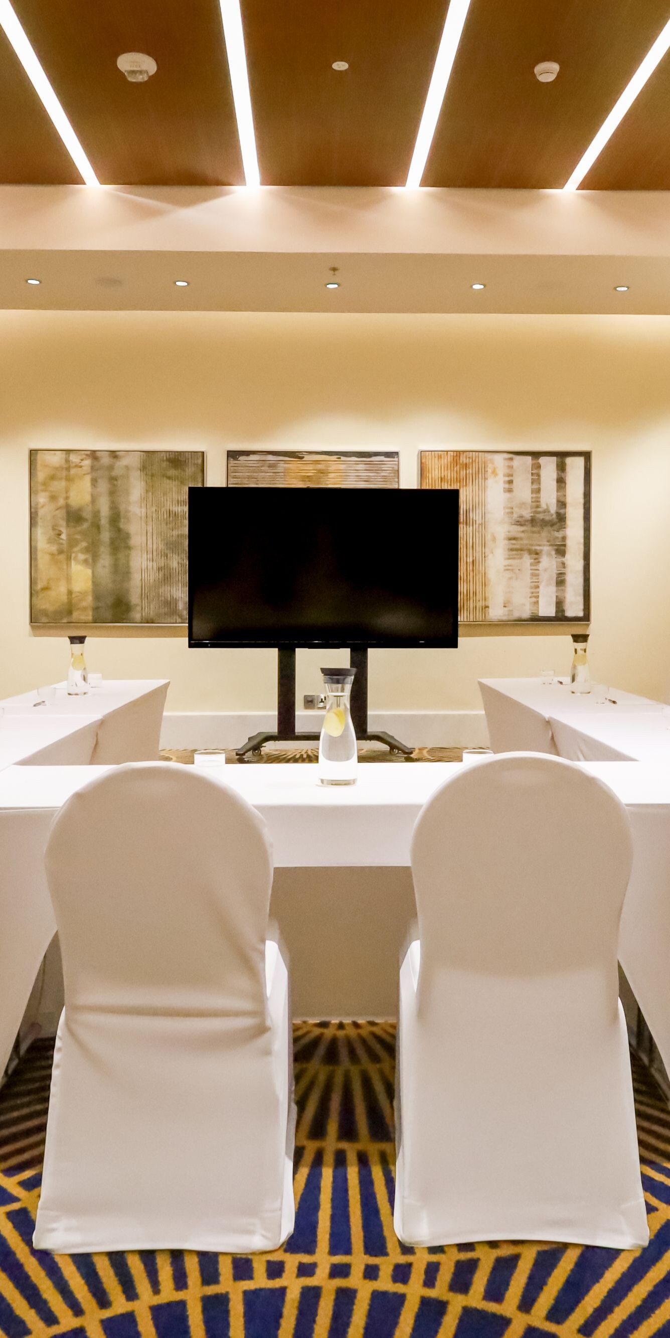 Meeting room with U-shape table and TV