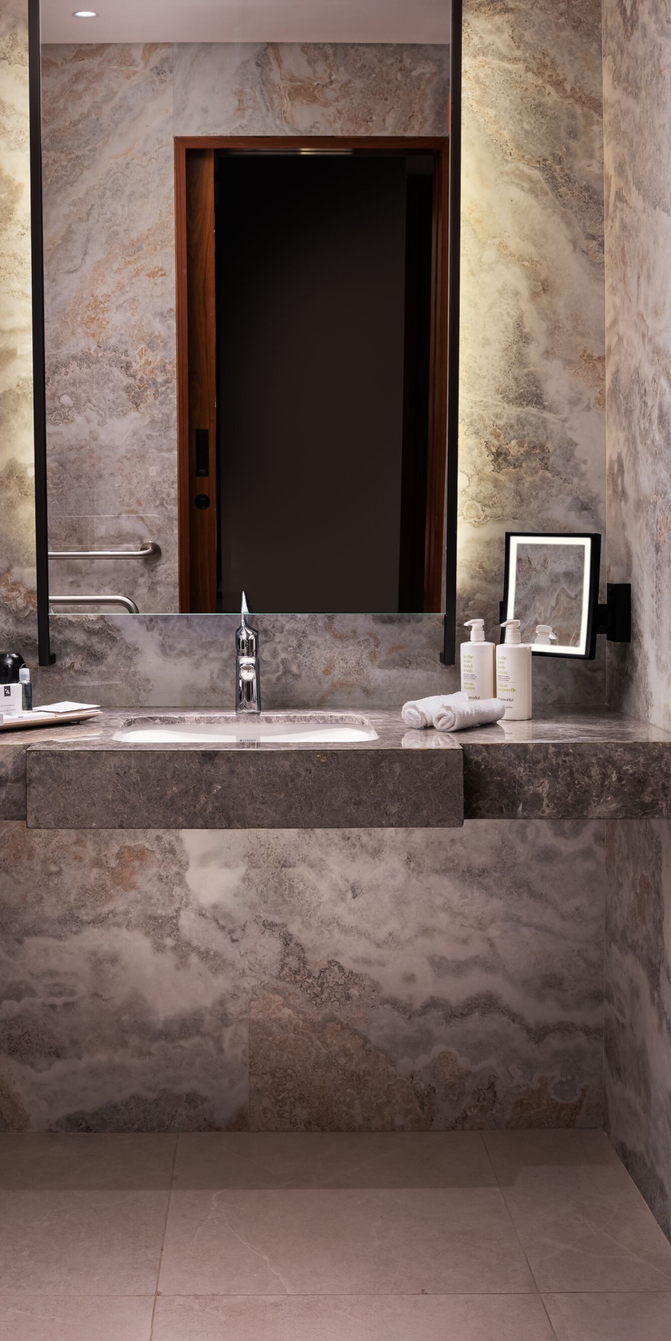 Bathroom with marble surfaces and shower