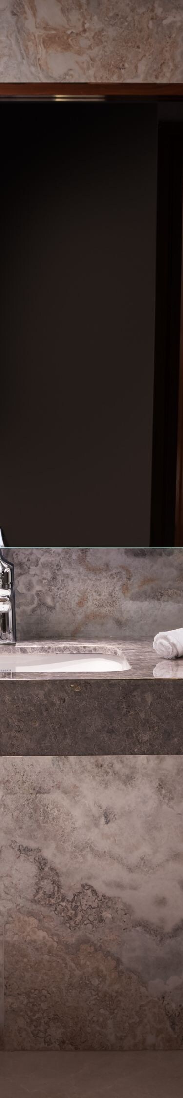 Bathroom with marble surfaces and shower