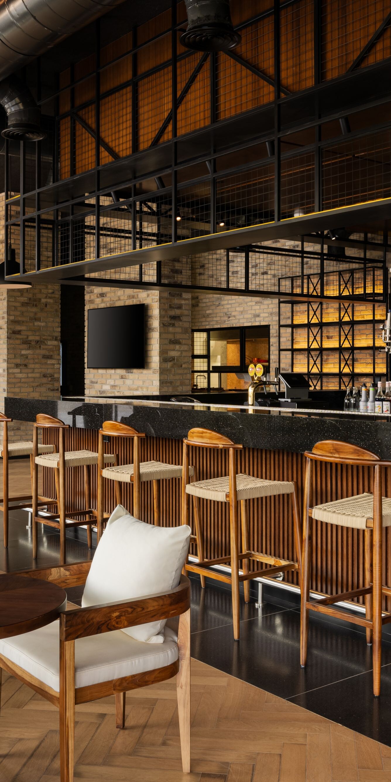 Modern bar with wood stools and brick walls