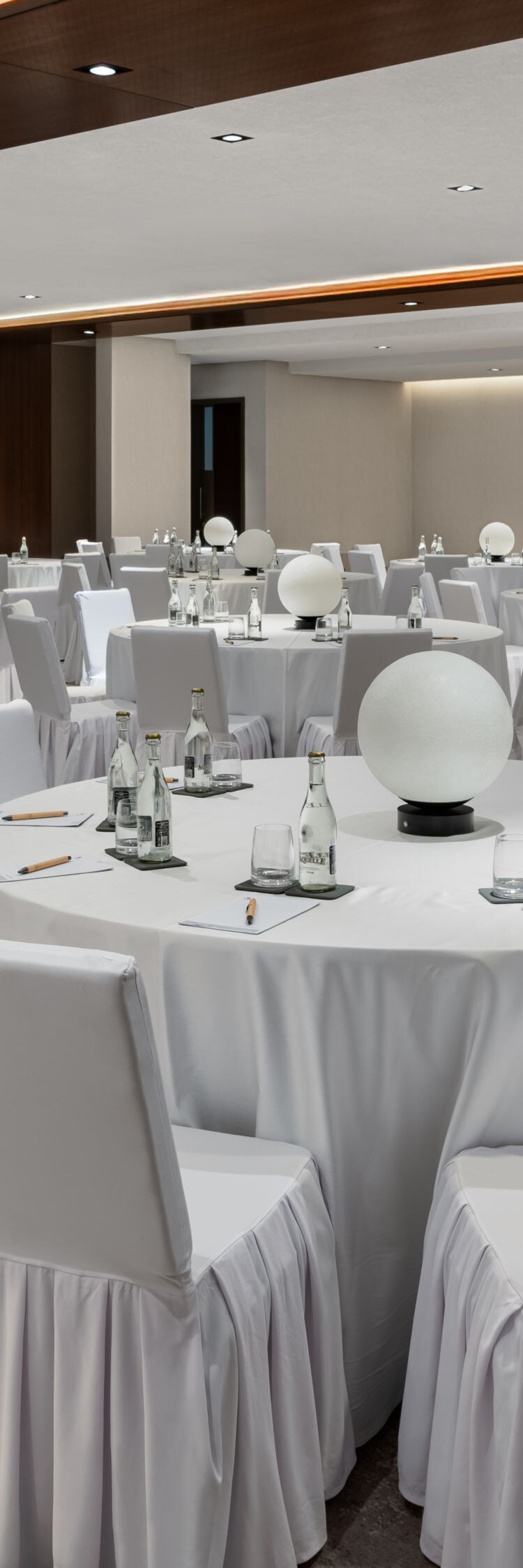 Ballroom with banquet setup and lighting