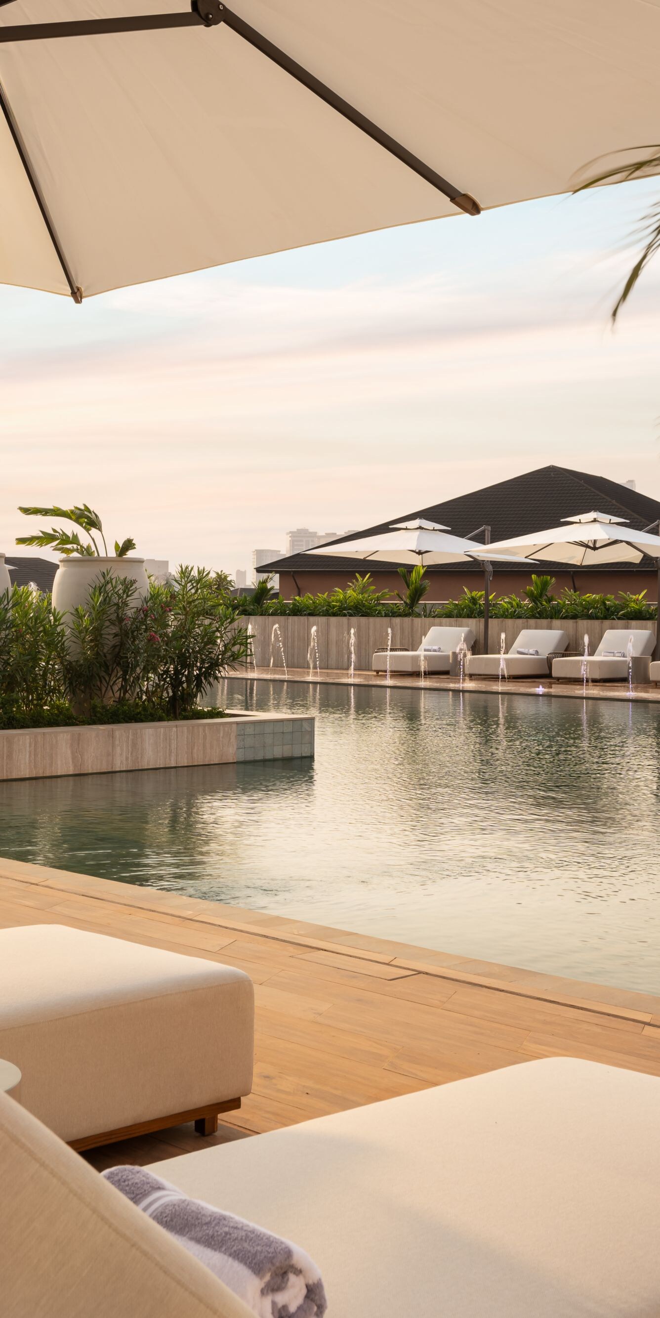 Outdoor pool with lounge chairs and umbrellas