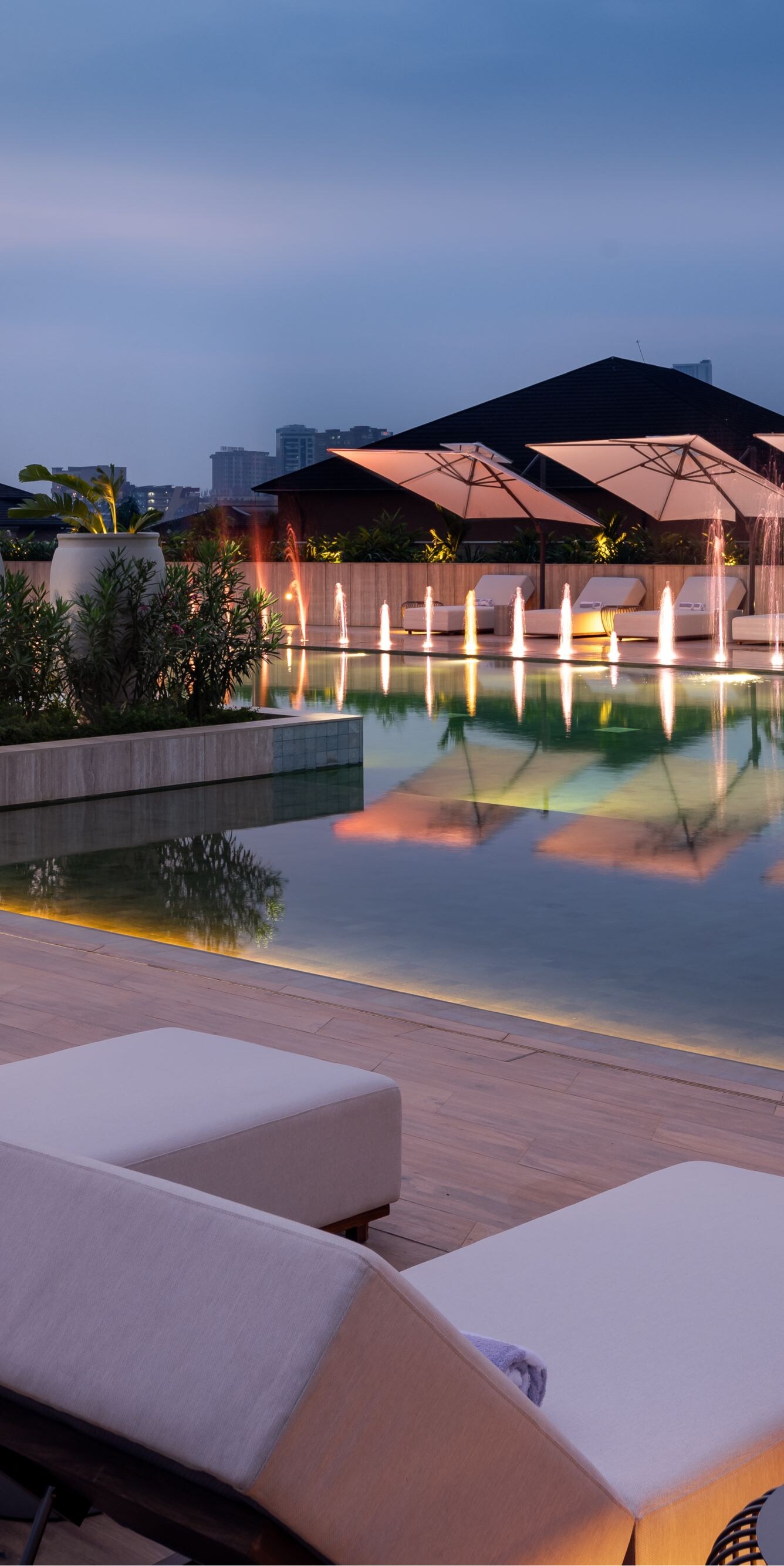 Rooftop pool with fountains and city views