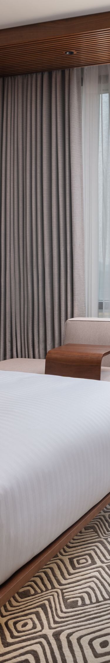 suite bedroom with city view and desk
