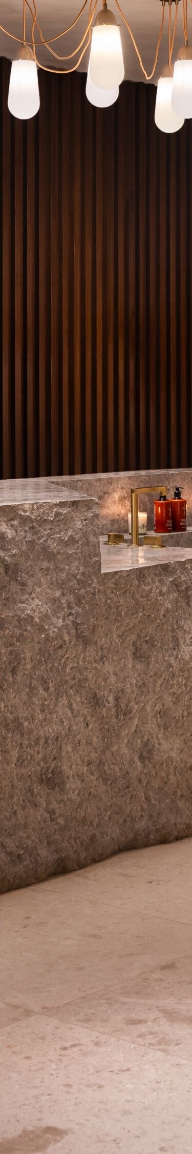 Spa reception with stone desk and shelving