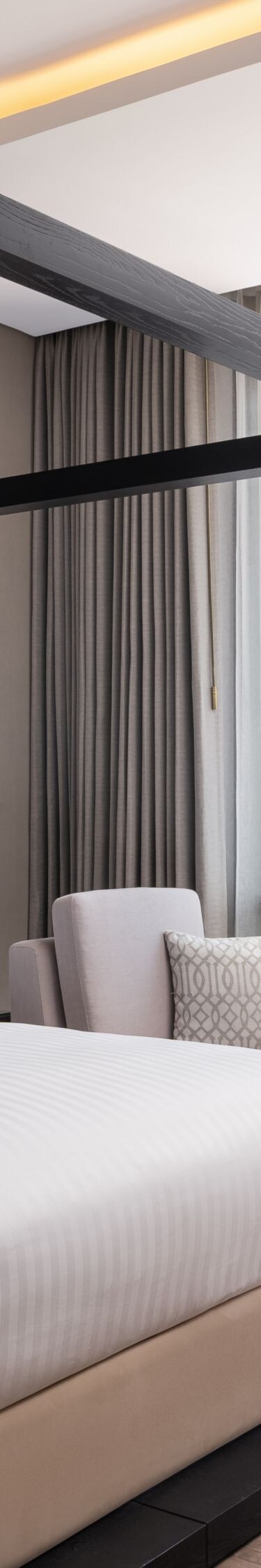 suite bedroom with canopy bed and city view