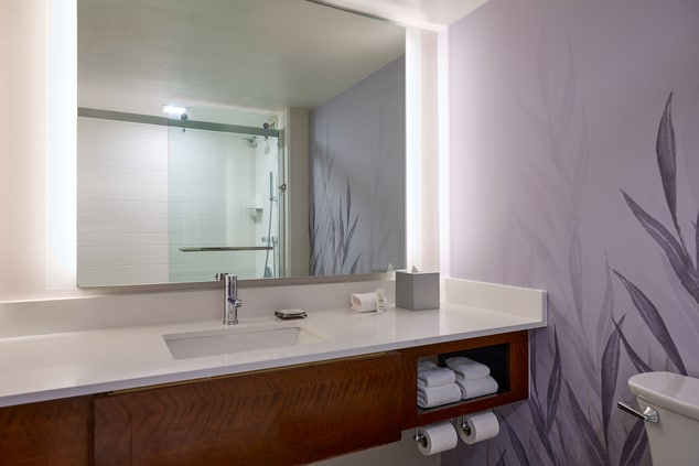 Bathroom mirror with shower in background