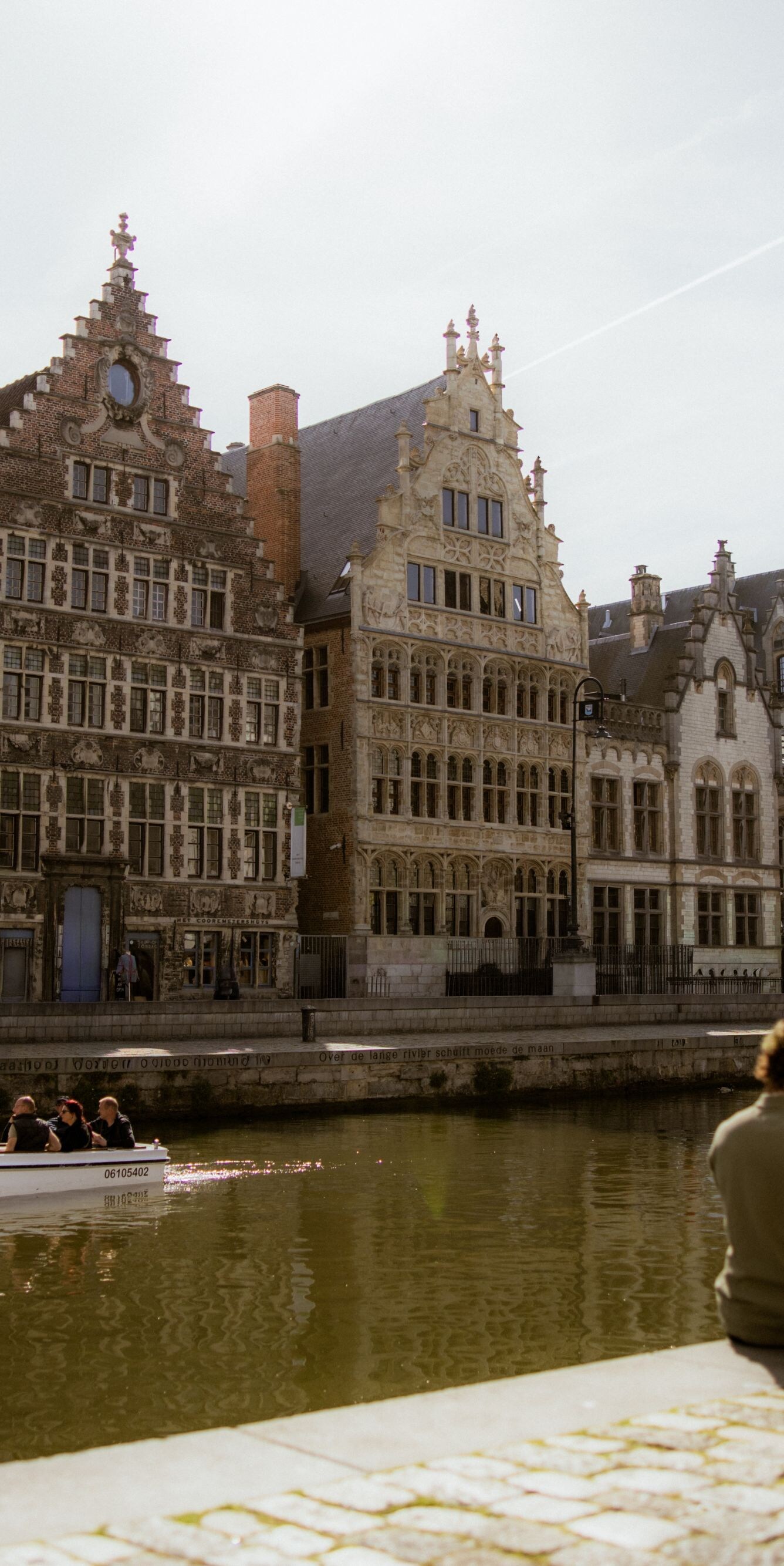 Couple sitting by the canal in historic Ghent