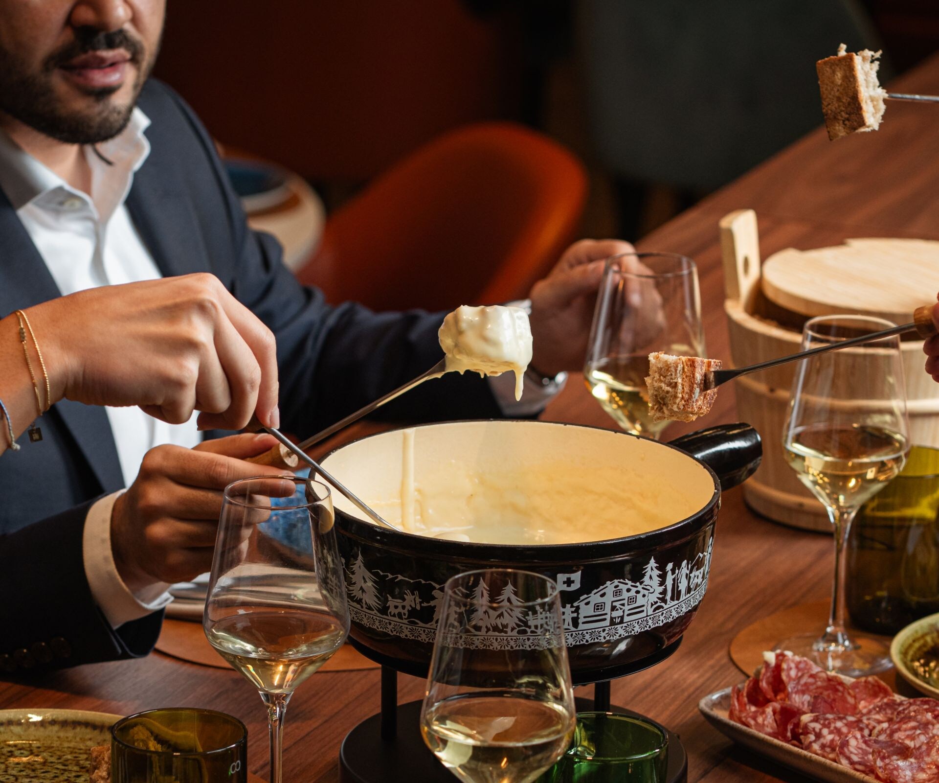 Group sharing fondue at dinner table