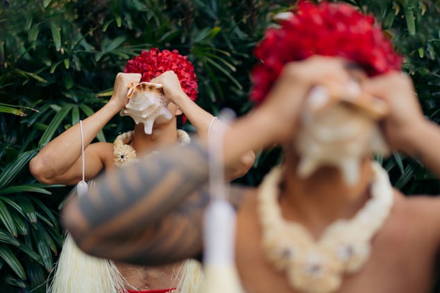 Hula performers using the conch