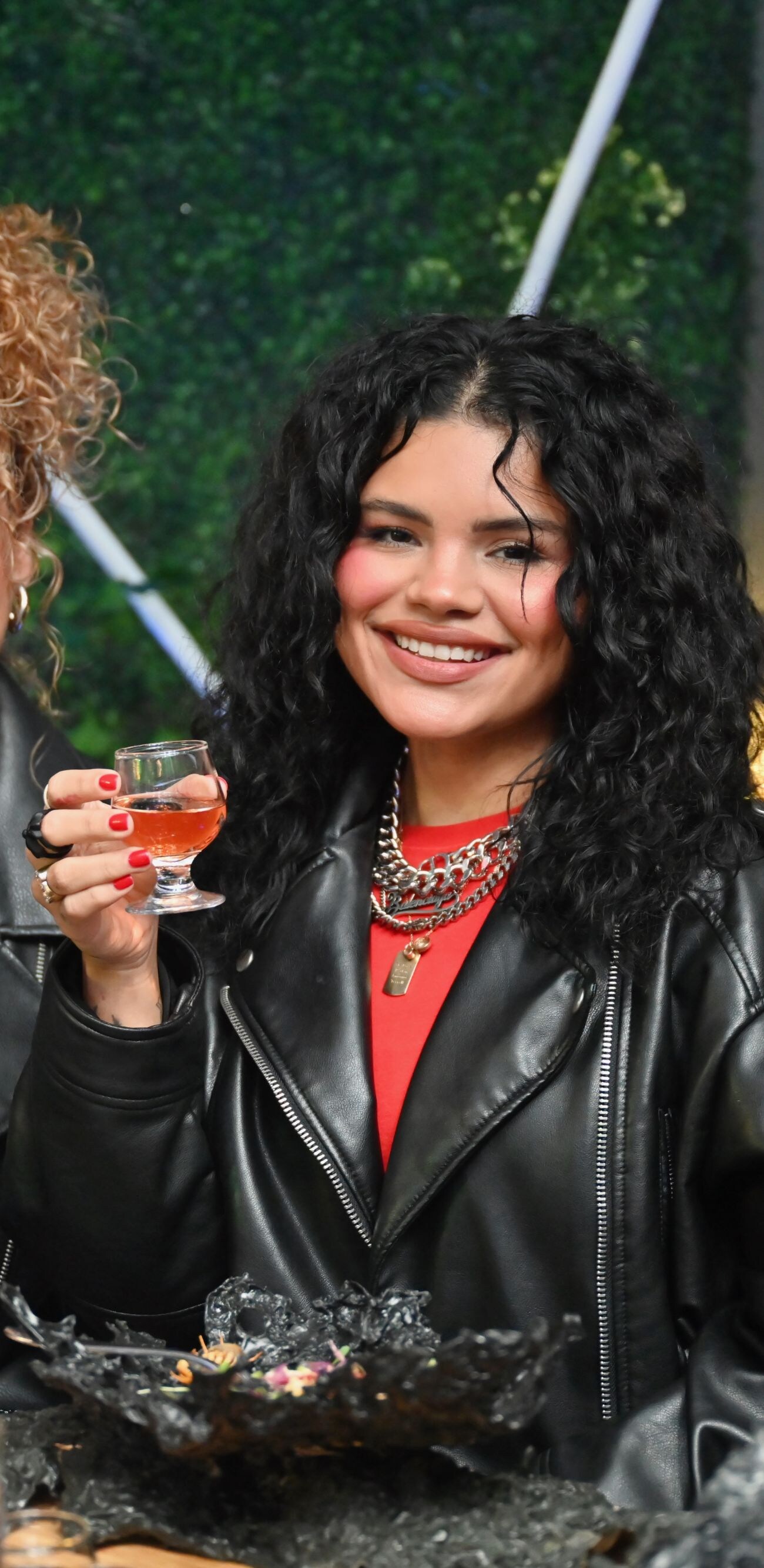 Two people holding up glasses