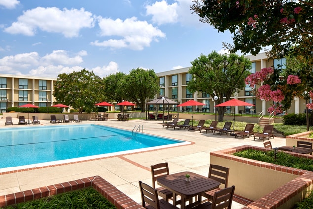 Outdoor pool with lounge chairs in the hotel court