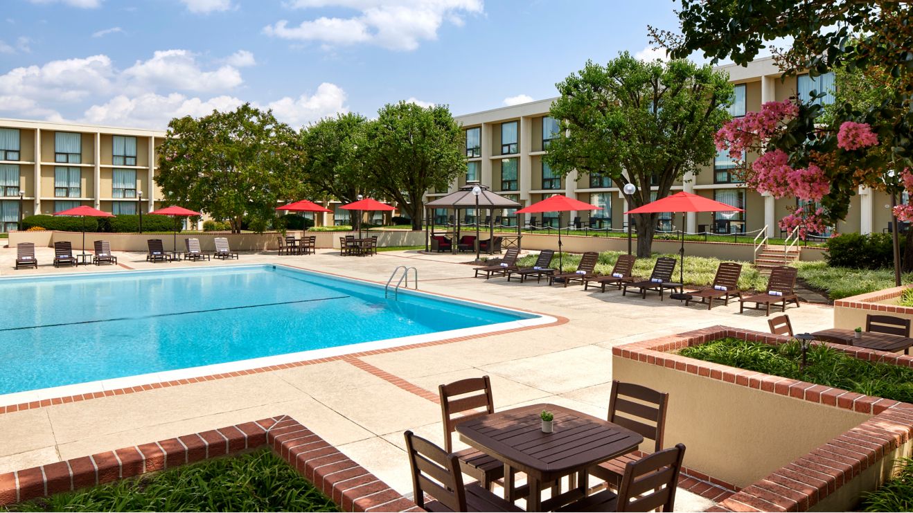 Outdoor pool with lounge chairs in the hotel court