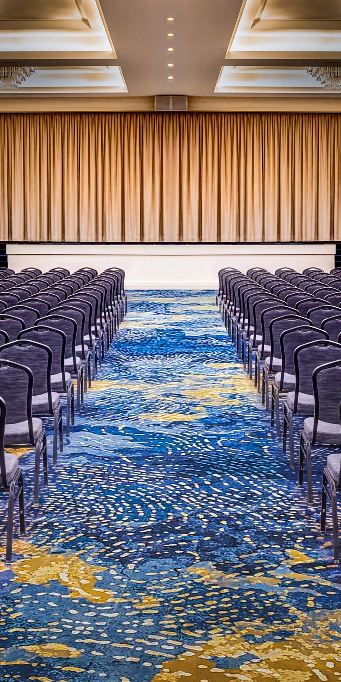 Ballroom set with banquet tables and stage