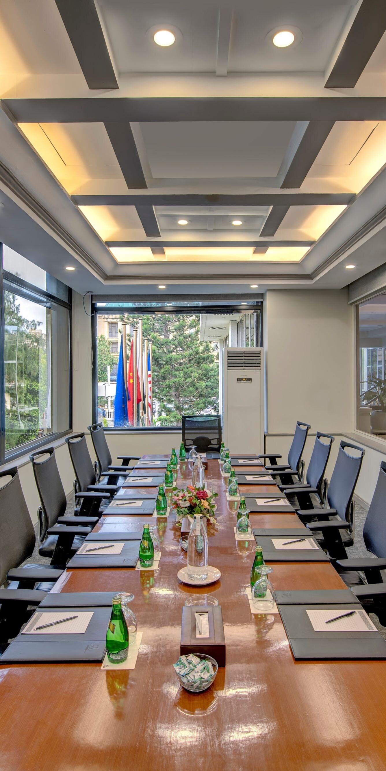 Boardroom table with chairs and water bottles
