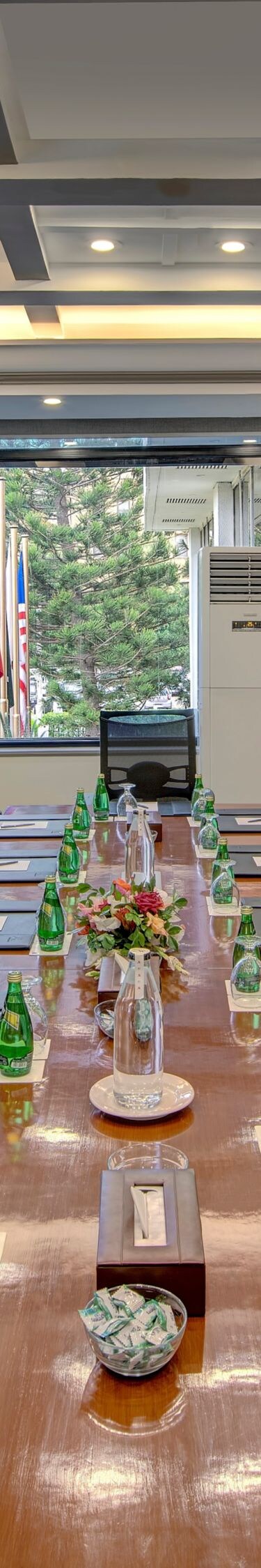 Boardroom table with chairs and water bottles