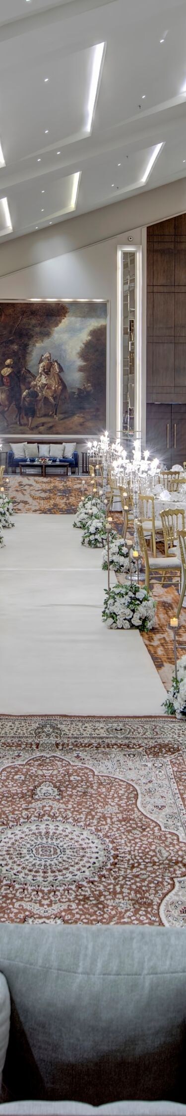 Grand ballroom with tables and central aisle