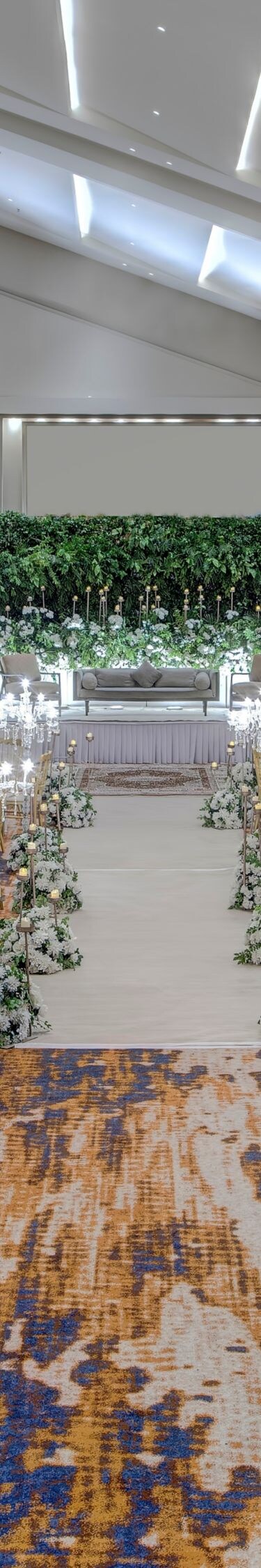 Ballroom wedding setup with tables and aisle