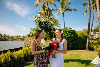 brides holding bouquets at outdoor venue