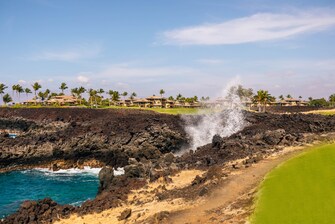 The ocean splashes, lava rocks, golf green