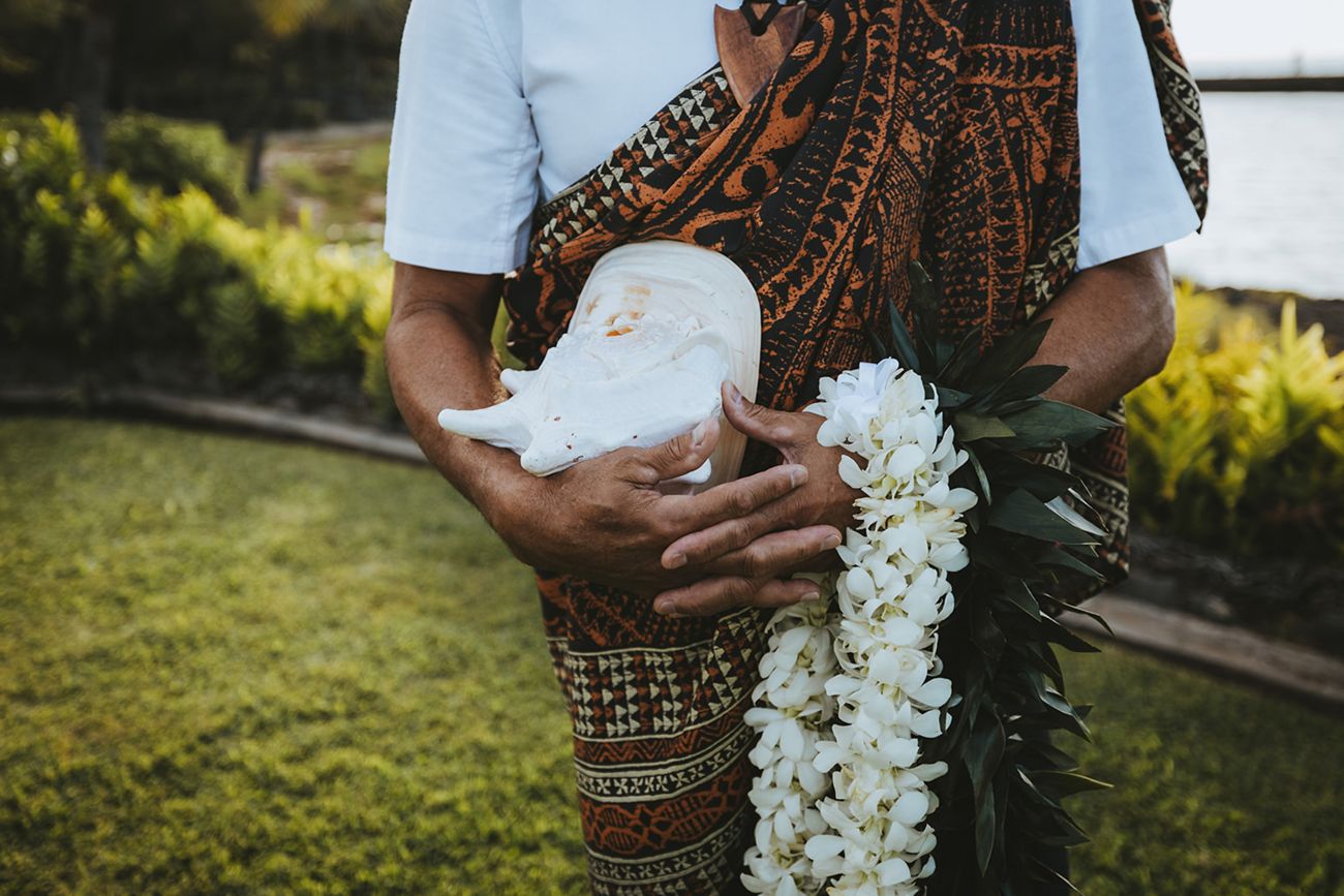Hawaiian officiant, conch shell, leis, ceremony