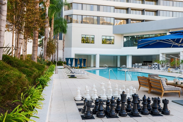 life size chess set by pool