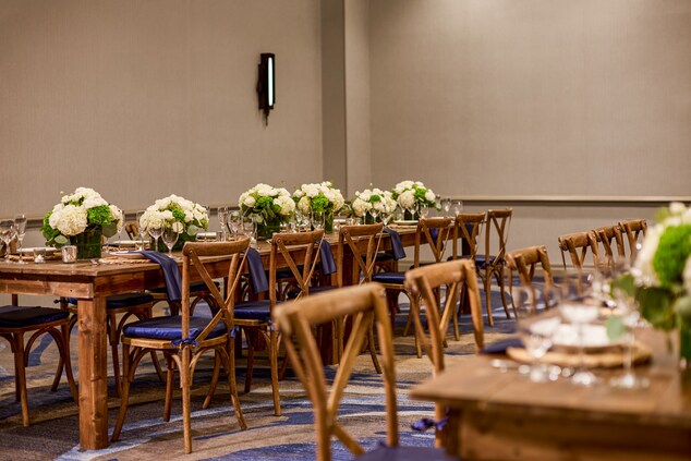 Long tables set for an event with floral arrangeme