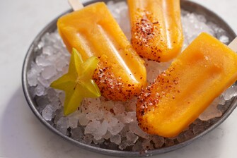 Mango popsicles with tajin on ice