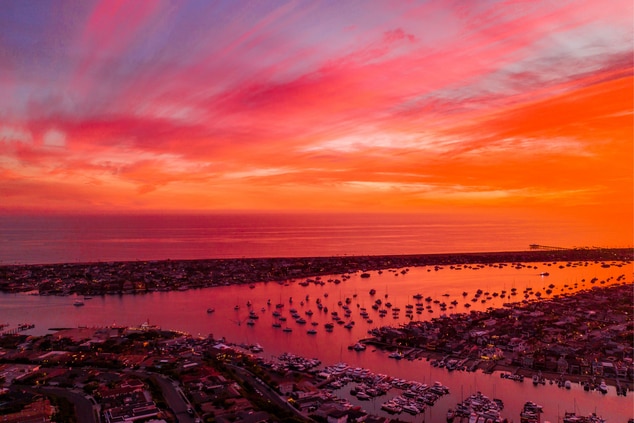 Newport Harbor at sunset with pink skies