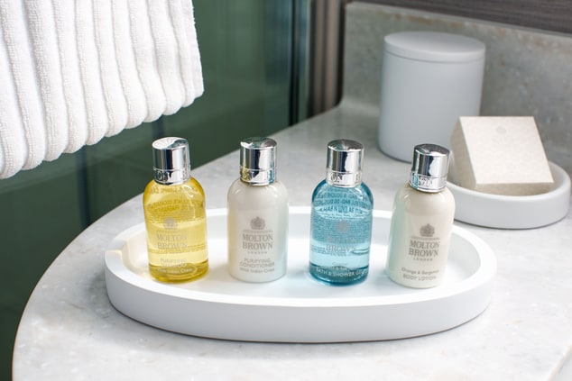 Four bottles of Molton Brown bath amenities in the