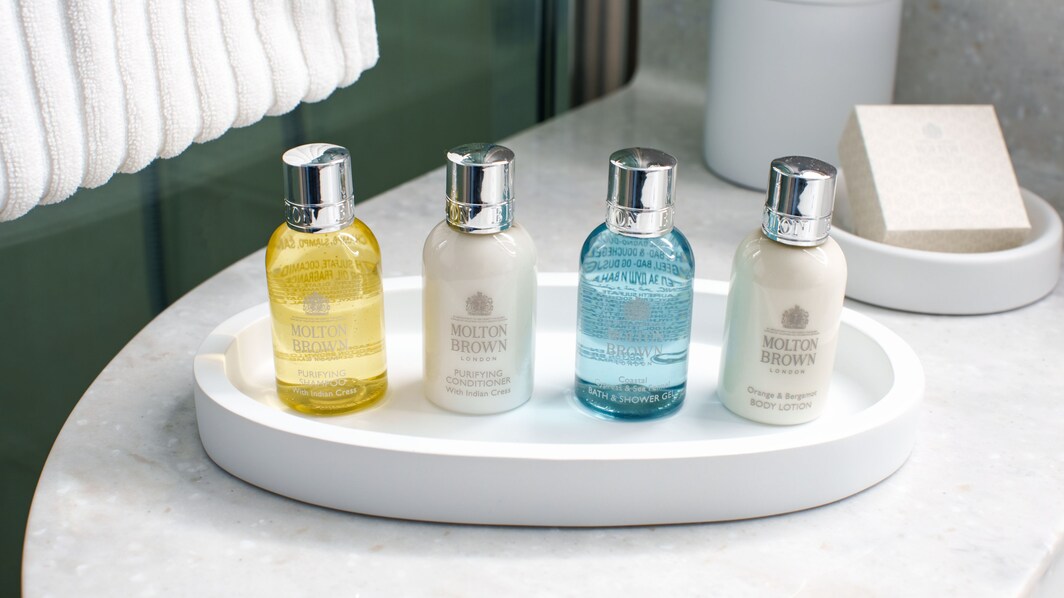 Four bottles of Molton Brown bath amenities in the