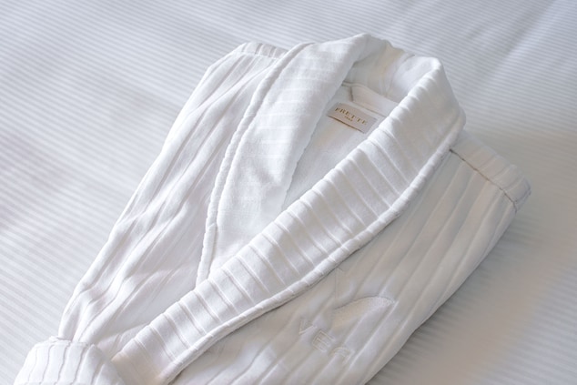 White Frette robe on a bed