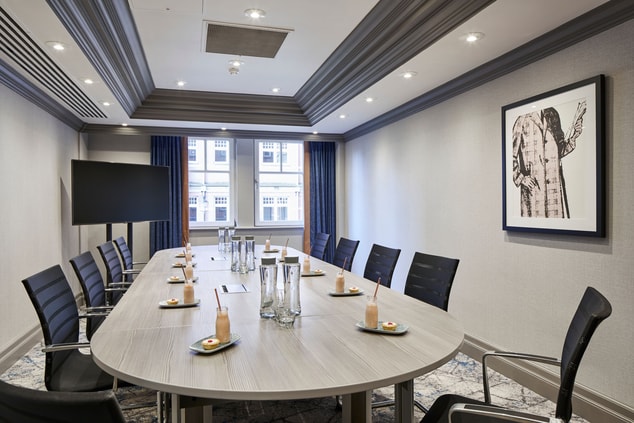 meeting room/boardroom with oval desk and chairs