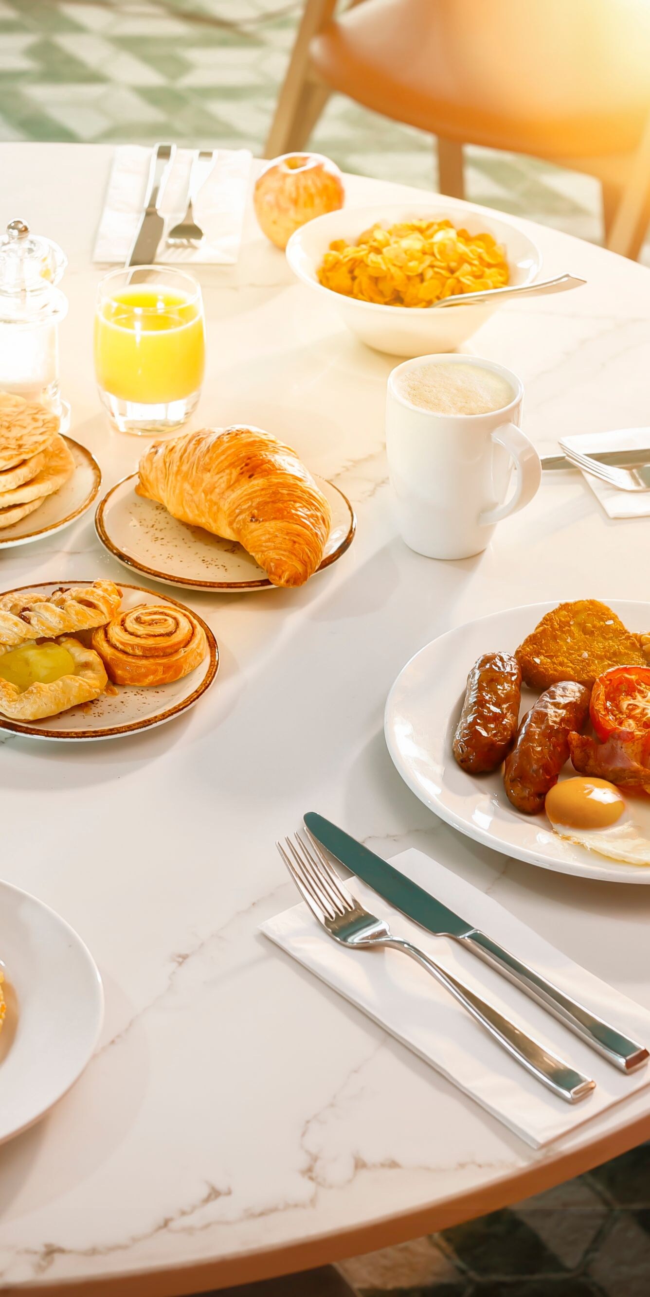 Breakfast table with hot dishes and pastries