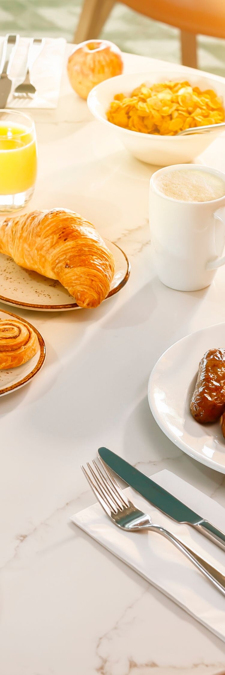 Breakfast table with hot dishes and pastries