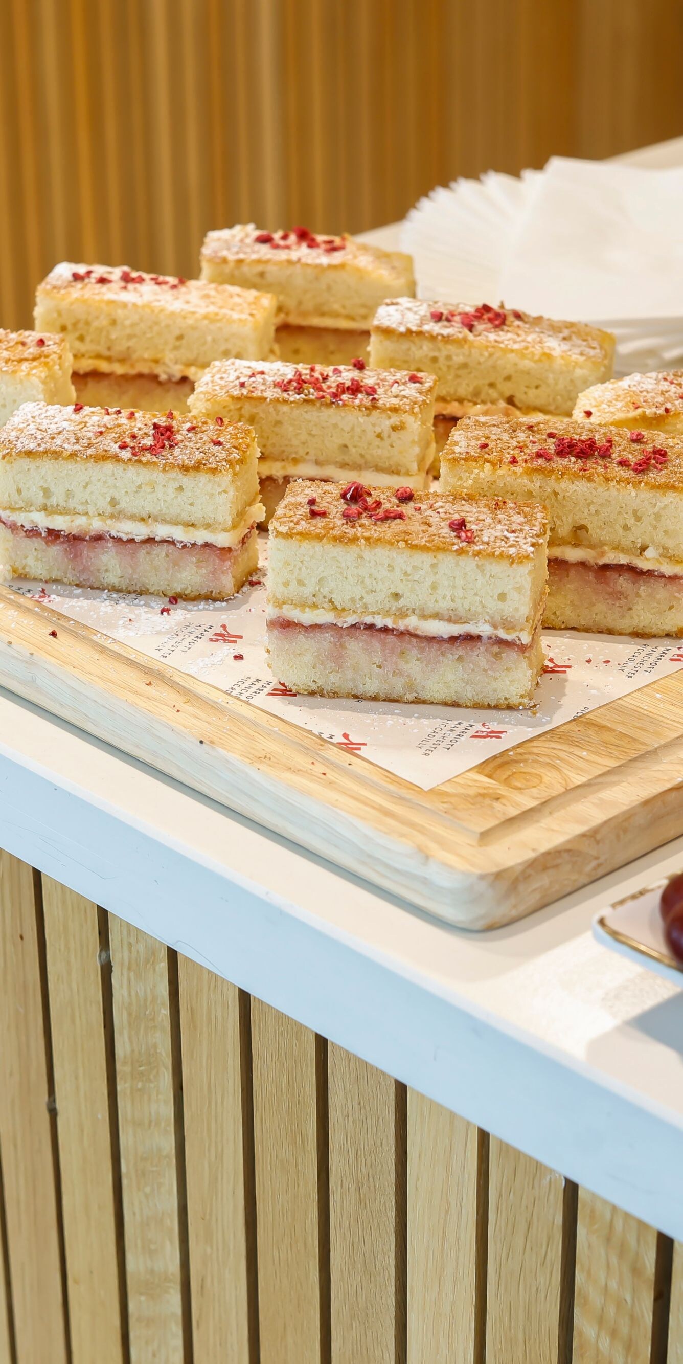 Sponge cake slices beside a fresh fruit platter