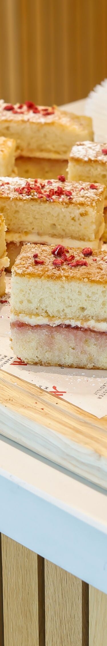 Sponge cake slices beside a fresh fruit platter