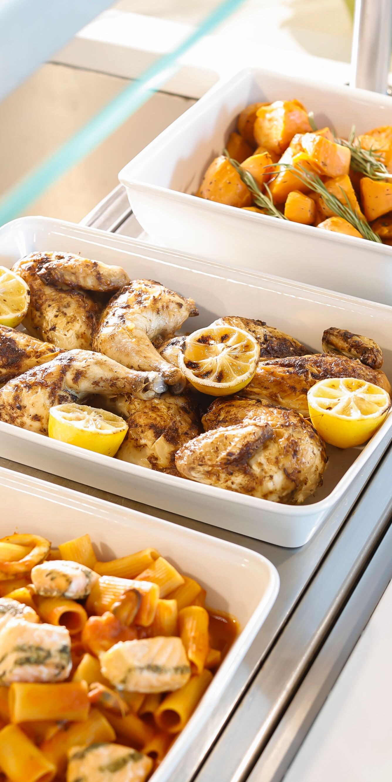 Hot buffet with pasta, chicken and potatoes