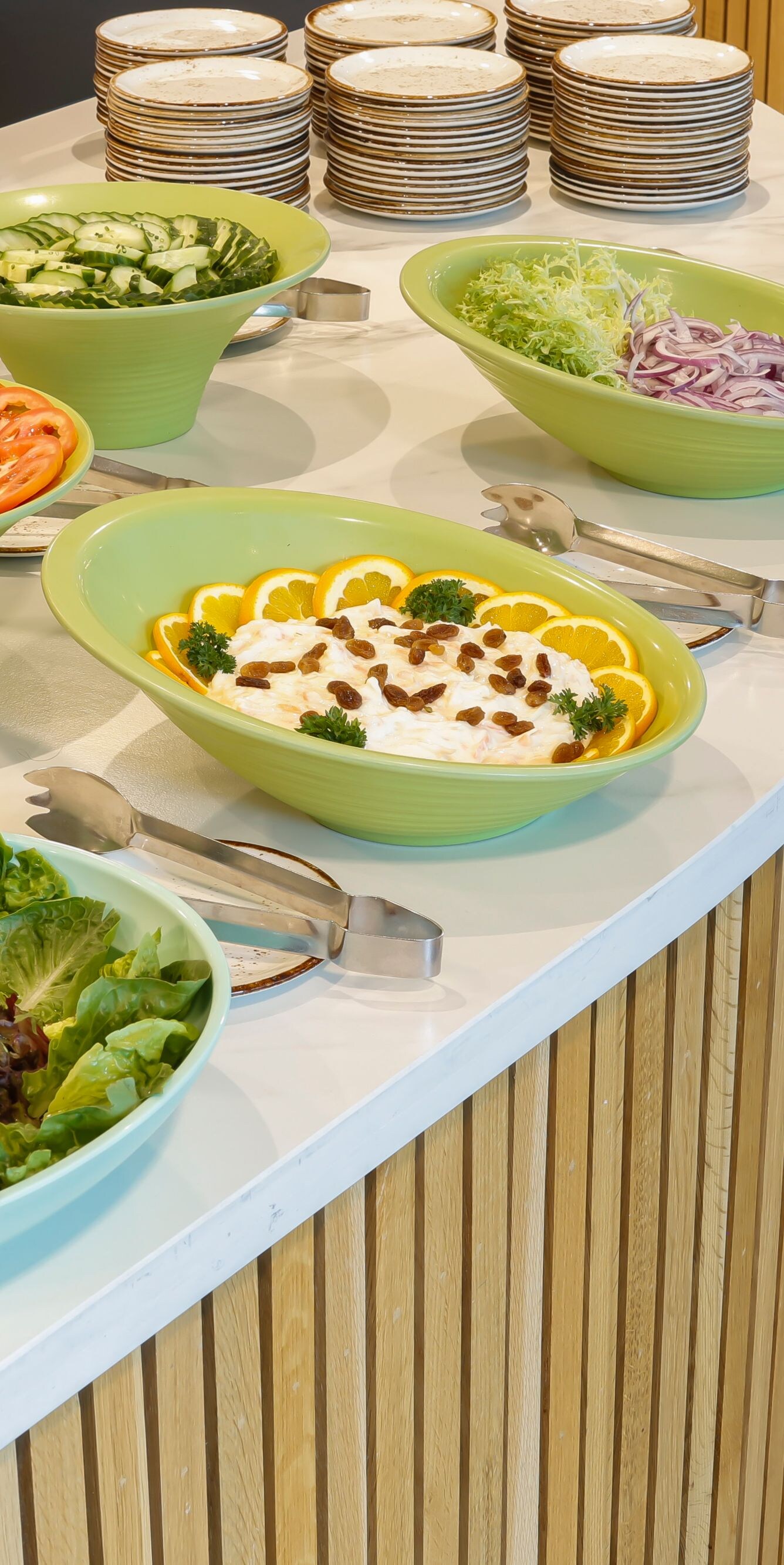 Lunch buffet with bowls of fresh salad