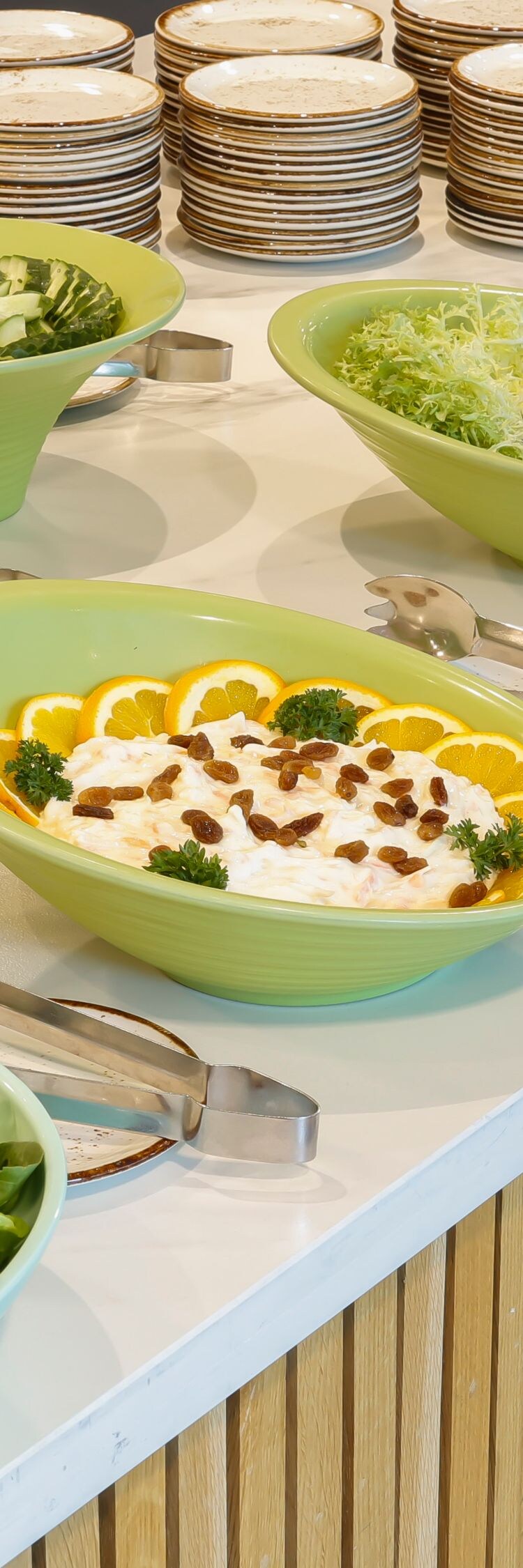 Lunch buffet with bowls of fresh salad