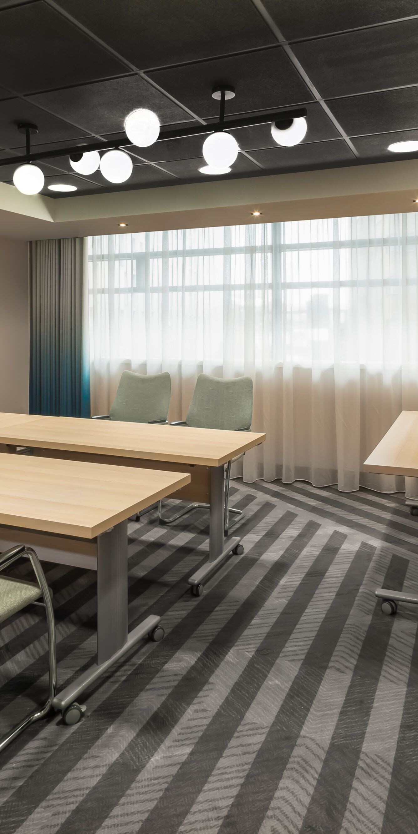 Boardroom table facing presentation screen