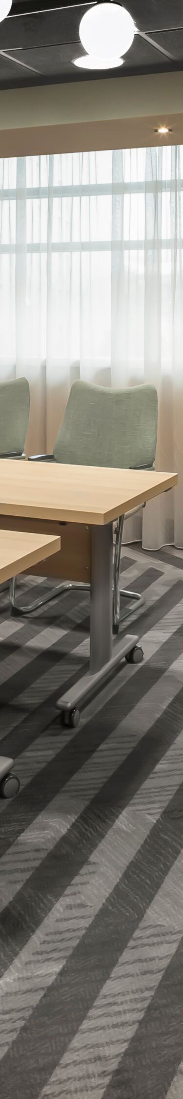 Boardroom table facing presentation screen